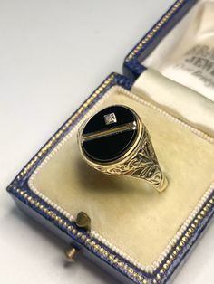 A beautiful vintage 9 karat gold ring. Featuring a beautiful round black onyx with a natural small diamond in the centre with stunning floral scroll work to the left and right. Hallmarked 375 for 9 karat gold and made in the exact year of 1987. The perfect ring to wear for any occasion! Size UK/AUS V Size US 10 3/4 Condition: In above excellent vintage condition. Please look at the photos as they are truly representative of the condition of this amazing ring! All our items are including postage Antique 14k Gold Signet Ring With Gemstone, Antique Signet Ring As Gift, Oval Black Enamel Diamond Jewelry, Oval Diamond Jewelry With Black Enamel, Classic Black Enamel Diamond Rings, Classic Diamond Ring With Black Enamel, Classic Diamond Rings With Black Enamel, Antique Signet Ring With Black Enamel For Gift, Elegant Onyx Signet Ring As Gift