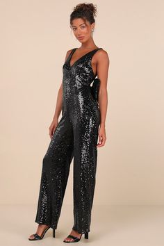 Walking in like you own the place is exactly how the Lulus Feeling Sparkly Black Sequin Bow Wide-Leg Jumpsuit is supposed to make you feel! This fabulous jumpsuit is sure to make you the shiniest sight in any room with its dazzling black sequin composition that shapes a princess-seamed bodice with a V-neckline and a flirty open back design, all supported by wide straps. The high fitted waist tops trendy wide pant legs that fall to ankle-grazing hems. The dramatic, oversized bow detail at the back is sure to make heads turn and secures via snap closures for easy on-and-off! Hidden back zipper/clasp. Fit: This garment fits true to size. Length: Floor length. Size medium measures 57" from shoulder to hem. Bust: Great for any cup size. Waist: Fitted - very fitted at natural waist. Hip: Loosely Bow Jumpsuit, Sparkly Jumpsuit, Disco Fashion, Tops Trendy, Sequin Jumpsuit, Country Concert Outfit, Sequin Bow, Disco Outfit, Wide Pants