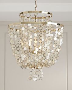 a chandelier hanging from the ceiling in a room with white walls and doors