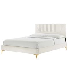 a white bed with gold legs and headboard on it's side, against a white background