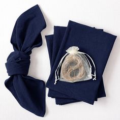 three pieces of cloth tied together with a knot on the top and one piece of fabric wrapped around it