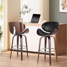 two black bar stools sitting in front of a desk with a laptop on it