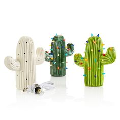 three ceramic cactus ornaments with lights on them