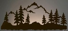 the silhouette of a mountain with trees on it