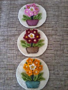 three plates with flowers on them sitting on a table