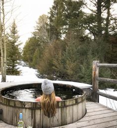 a woman sitting in an outdoor hot tub