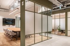 an empty conference room with glass partitions