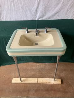 a small sink sitting on top of a wooden table