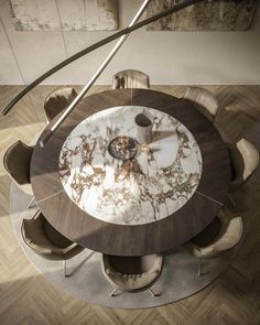 a round marble table with chairs around it