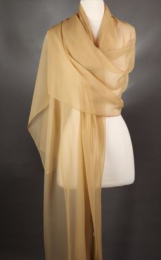 This is a shorter scarf but has fluidity and the color is a muted beige....very beautiful!  Perfect for year round.  All of my scarves can be dressed up or down. I finish my scarves with a machine rolled hem.  I am constantly looking for unusual fabrics that would make wonderful scarves. Be nice to your scarves and they will last a long, long time. Enjoy the scarf and wear it with confidence. Polyester Measures approx.:   100 L  28 W ins. Quantity:  (1) Colors might be slightly off on your compu Scarf Dress Outfit, Ladies Gifts, Short Scarves, Neck Scarf Tying, Gold Scarf, Beige Scarf, Fall Scarves, Scarf Dress, Scarf Gift