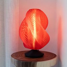 an orange lamp sitting on top of a wooden table