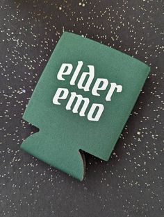 a can cooler with the word elder emo printed on it sitting on a table