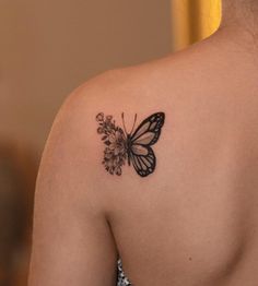 a woman with a butterfly tattoo on her shoulder