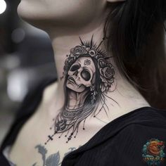 a woman's neck with a skull and flowers on it