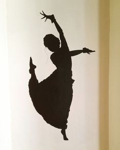 a black and white photo of a ballerina in the air with her arms outstretched