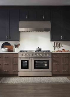 a stove top oven sitting inside of a kitchen next to wooden cabinets and counter tops