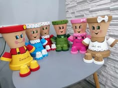 a group of toy figurines sitting on top of a table next to each other