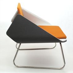 an orange and black chair sitting on top of a metal stand