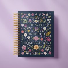 the well ordered homeschool book on a purple surface with flowers and leaves around it