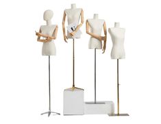 three mannequins are standing next to each other in front of a white box