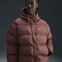 Up your outerwear game in this insulated puffer jacket. A loose fit makes it ideal for layering while the Nike Therma-FIT technology helps manage your body’s natural heat to help keep you warm in cold-weather conditions. A water-repellent finish, bungees at the hem and a hood work together to help shield you from wind and rain. Sporty Down Puffer Outerwear, Sporty Puffer Windbreaker For Cold Weather, Sporty Puffer Jacket With Padded Collar For Cold Weather, Sporty Puffer Jacket With Padded Collar For Outdoor Activities, Sporty Down Puffer Jacket With Adjustable Hood, Sporty Down Puffer Jacket With Detachable Hood, Fall Sportswear Puffer Jacket For Outdoor, Nike Winter Sports Puffer Jacket, Nike Puffer Jacket For Winter Sports