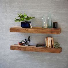 two wooden floating shelves with plants and books on them, one shelf is made out of wood