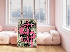 a poster with the words i love money and money loves me on it in front of a couch