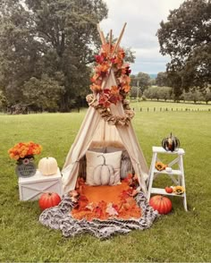 a teepee with pumpkins and other decorations on it