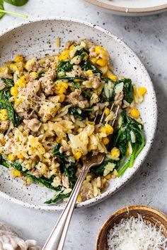 a white bowl filled with rice and vegetables next to two bowls full of other food