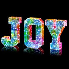 the word joy is made up of colorful lights