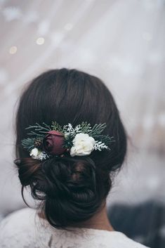 a woman with flowers in her hair wearing a flower headpiece on her wedding day