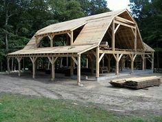 a large wooden building sitting in the middle of a forest