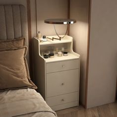 a bedroom with a bed, night stand and lamp on the nightstand next to it