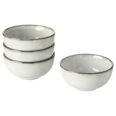 four white bowls stacked on top of each other in front of a white background with silver rims