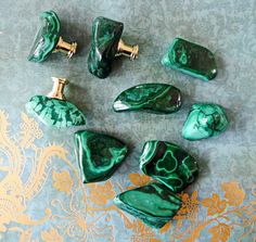 some green marble pieces are on a table