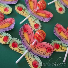 some candy lollipops are sitting on top of each other in the shape of butterflies