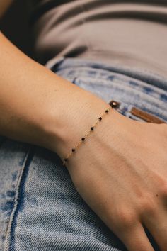 From our Color Romance Collection, this black enamel beaded piatto chain will add a pop of color to any outfit. Crafted in 14K gold, this 1 inch adjustable chain secures with a spring ring. NECKLACE DETAILS: Length: 7.5 Inches Millimeter: 1.7 Gauge: 030 Average Weight (g): 0.73 Closure: 5.0m Spring Ring Available in 14K Yellow Gold ***These necklaces have a 4 week lead time. If you need your necklace sooner than that, please contact us prior to ordering to verify if that's possible.*** | Black Enamel Bead Piatto Chain Bracelet In 14K Yellow Gold Ring - by Staghead Designs - Unisex Minimal Bangles Jewelry, Elegant Black Chain Bracelet With Adjustable Chain, Elegant Black Chain Bracelet As Gift, Minimalist Onyx Round Bead Jewelry, Minimalist Onyx Bead Jewelry, Black Bracelet With Adjustable Chain For Everyday, Elegant Black Beaded Bracelet With Adjustable Chain, Minimalist Onyx Jewelry With Black Beads, Everyday Onyx Jewelry With Black Beads