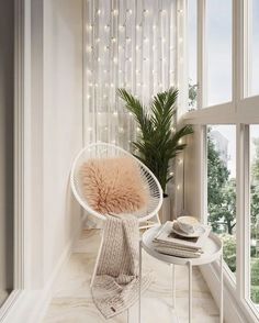 a white chair sitting next to a window covered in lights