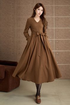 Step into timeless elegance with this vintage-inspired brown dress. Crafted from a smooth, woolen fabric, this mid-length dress features a flattering V-neckline and long sleeves. The flared skirt adds a touch of femininity and movement, making it ideal for both casual outings and special occasions. DETAIL * 30% wool, 30% fiber, 40% polyester * fully satiny lining, more nice to the touch body * Long sleeves dress * Fit and flare dress * Right zipper closure * Two side seam pockets * Belted dress * Mid-calf length dress * Vintage wool dress * Perfect for autumn, winter * Lean More about the items From the FAQs on the page bottom MODEL SIZE Bust 85 cm(33.4") Waist 67 cm(26.7") Height 168cm (5' 6") She wears size XS Choose CUSTOM Order if you * Need a better fit * Can't find your size in our s Midi Dress A Line, Long Sleeves Dress, Dress Autumn, Calf Length Dress, Dress Long Sleeves, Sleeves Dress, Winter Dress, Mid Dresses, Mid Length Dresses