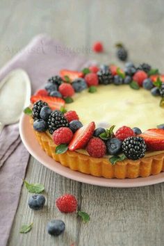 a cake with berries and blueberries on top