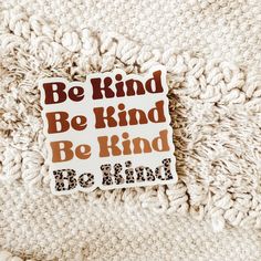 a sticker with the words be kind, be kind written in brown on it