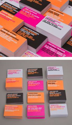 several business cards stacked on top of each other in different colors and sizes, with the same logo printed on them