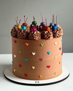 a cake with chocolate frosting and hearts on it