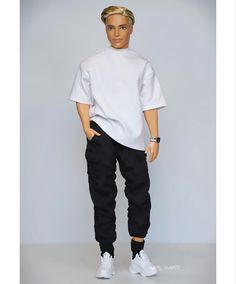 a barbie doll wearing a white shirt and black pants