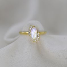 Fit for a princess, our ring with the beautiful Rainbow Moonstone the is an exquisite ring perfect for a wedding anniversary, pre-engagement ring, or as something special for a loved one.                                                         ►Gemstone: Natural Rainbow Moonstone ►Base Metal: Solid 14k Gold  ►Plating: 18k Gold Vermeil ★Natural Rainbow Moonstone stone cannot be always the same, gemstone colour may change in different light/background condition. ★Gemstone size: ★Center Stone - 5 m Rose Gold Moonstone Ring, Pre Engagement, Gold Moonstone Ring, Moonstone Engagement, Moonstone Engagement Ring, Moonstone Stone, Light Background, Natural Rainbow, Beautiful Rainbow