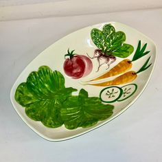 a plate with vegetables painted on it