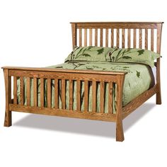 a wooden bed with green bedspread and pillows