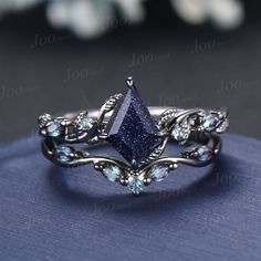 a close up view of a ring with blue stones