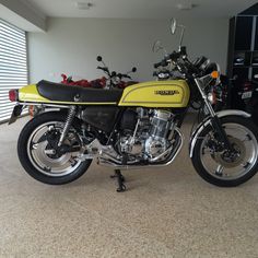 a yellow and black motorcycle parked in a garage