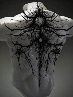 the back of a mannequin's head with tree branches on its body